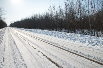 Winter road. the track of the car leading into the distance