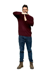 Fototapeta premium Full-length shot of Handsome man with glasses making stop gesture with her hand to stop an act on isolated white background