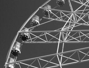 Ferris wheel under blue sky. Summer city park