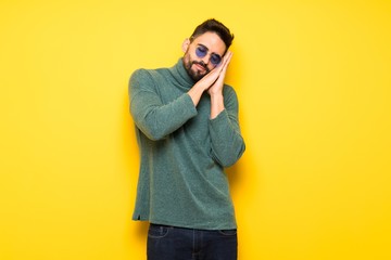 Handsome man with sunglasses making sleep gesture in dorable expression