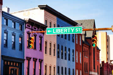 Guide sign at Baltimore street with colored houses