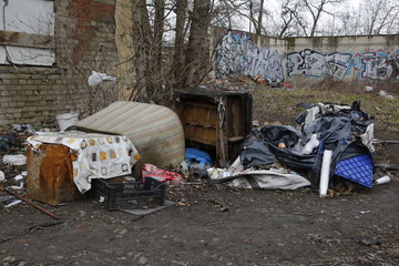 Environmental problems and nature pollution. Waste dumped in the city, an illegal social issue. Rubbish, garbage, outdoor, city, landscape, city space, abandoned area, ruined building