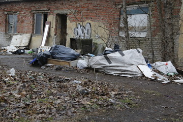 Environmental problems and nature pollution. Waste dumped in the city, an illegal social issue. Rubbish, garbage, outdoor, city, landscape, city space, abandoned area, ruined building