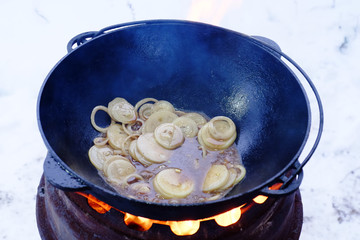 The process of cooking pilaf in a cauldron