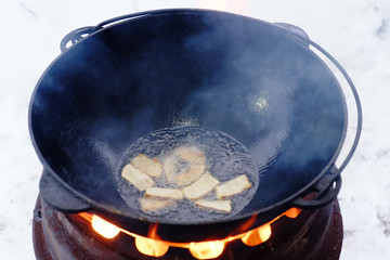 The process of cooking pilaf in a cauldron