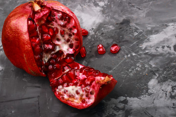 juicy ripe pieces of pomegranate on a dark background