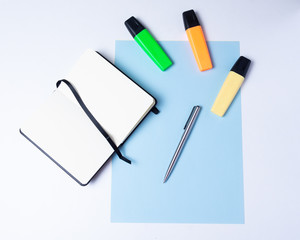 colorful highlighters, pen, markers, notebook and blank paper to work or study