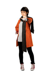 A full-length shot of a Short hair woman with coat making stop gesture denying a situation that thinks wrong over isolated white background