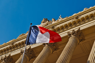 French flag on a windy day on a classic style building