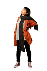 A full-length shot of a Short hair woman with coat suffering from backache for having made an effort over isolated white background