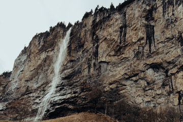 Waterfall in Lauterbrunnen, Switzerland. Winter landscape, cold.