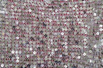 fabric with metal square sequins on a knitted gray basis
