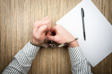 The process of opening handcuffs with pin. Concept attempt to escape from police.
