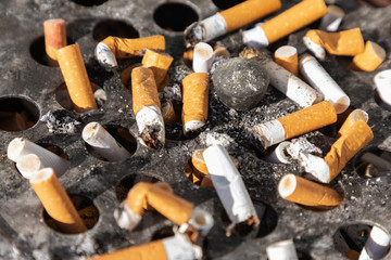 Cigarette ashtray close-up dirty ash ugly round metal 