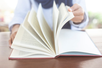 Women Muslim students studying and reading with books in  library, concept: Development of learning and education, workplace for knowledge outside the classroom, female young open textbook school 