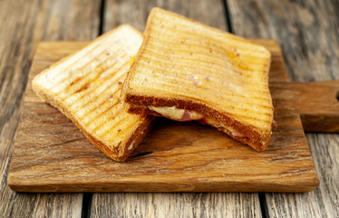 two sandwiches on a wood background