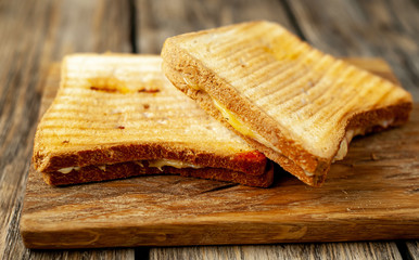 two sandwiches on a wood background
