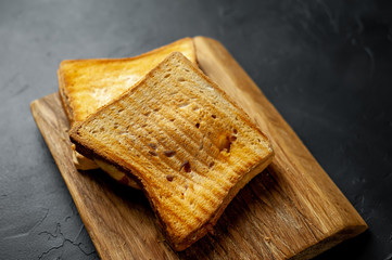 two sandwiches on a wood background