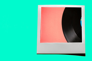 Instant photo on colored blue soft background. Polaroid vinyl