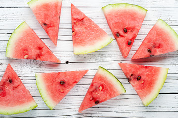slices of fresh watermelon on a rustic board