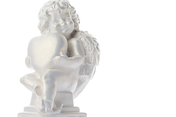 Cherub statue isolated on white background. Angel holds the heart. Love