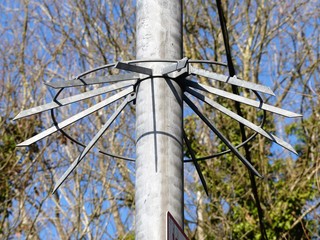 Anti-climb bracket attached to metal pole