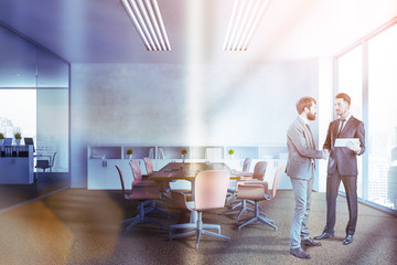People in white meeting room interior