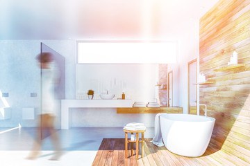 Woman in white and wood bathroom interior