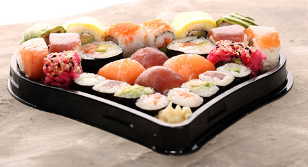 close up of sashimi sushi set with chopsticks and soy - sushi roll with salmon and sushi roll with smoked eel