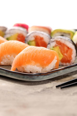 close up of sashimi sushi set with chopsticks and soy - sushi roll with salmon and sushi roll with smoked eel