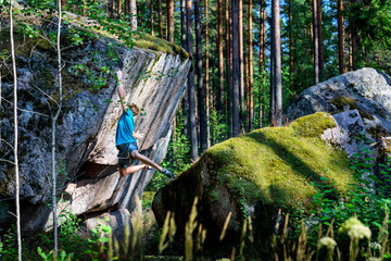 Male climber climbing overhanging rock. Boudering. Outdoor active lifestyle