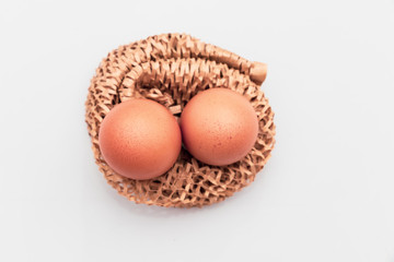Brown eggs in carton box flat lay Broken egg with yolk in background