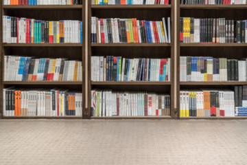 Many different books are on the shelf in the library
