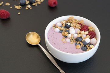 Blueberry yogurt with fresh berries on a wooden table.