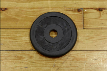 Free weight in the gym on wooden floor.