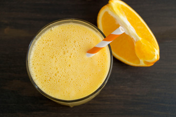 Healthy detox orange smoothie in a glass Cup.
