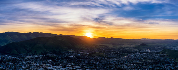 Panoramic Sunrise above Mountain and City © Mark