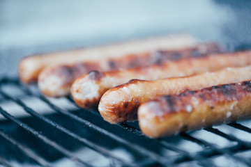 selective focus of tasty grilled sausages on bbq grill grade