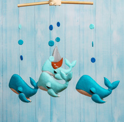 Colorful and eco-friendly children's mobile from felt. On blue background made from wood .