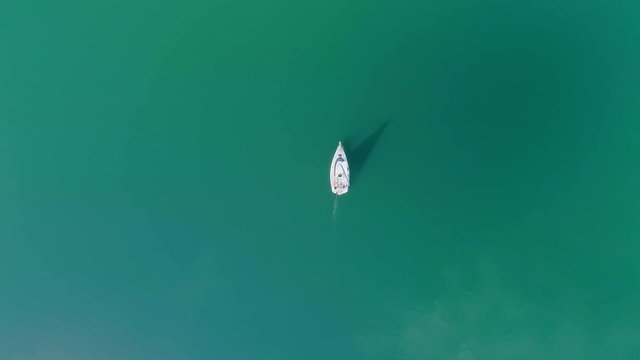 A small sailboat on the water. Sailing on the lake. Aerial view from drone, from above. Poland, Bieszczady, Solina