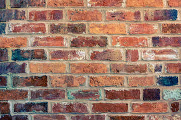 A brick wall built with old bricks which has been duo toned in yellow and blue