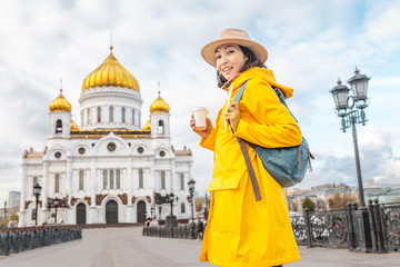 Obraz premium Happy asian tourist woman at the Cathedral of Christ the Savior. Travel and tourism in Russia and Moscow concept. Religion and faith