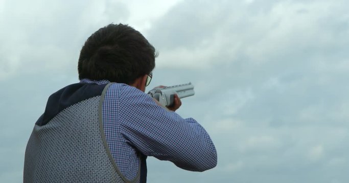 A Clay Pigeon or Skeet shooter hits the clay target in slow motion.