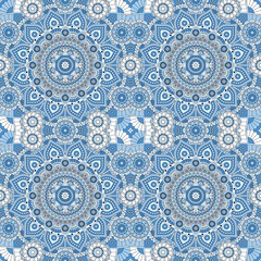 Seamless ornamental pattern in blue and white colors. Vector image.