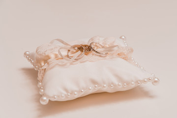 Silk pillow embroidered with pearls for wedding rings gently peach color close-up