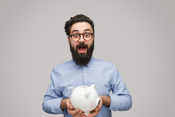 Excited male with piggy bank