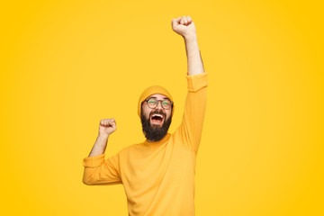 Excited bright man with fist up