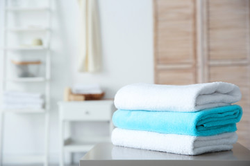 Stack of towels on table against blurred background
