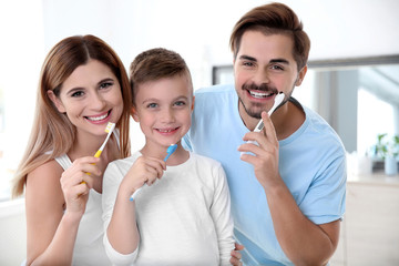 Portrait of happy family with toothbrushes in bathroom. Personal hygiene