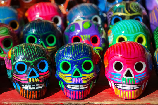 Multi-colored ceramic decorative skull. Traditional Mexican souvenirs. The symbol of the holiday of the day of the dead.